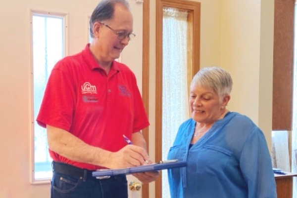 Lund's Carpet Cleaning technician reviewing service with a Spokane customer